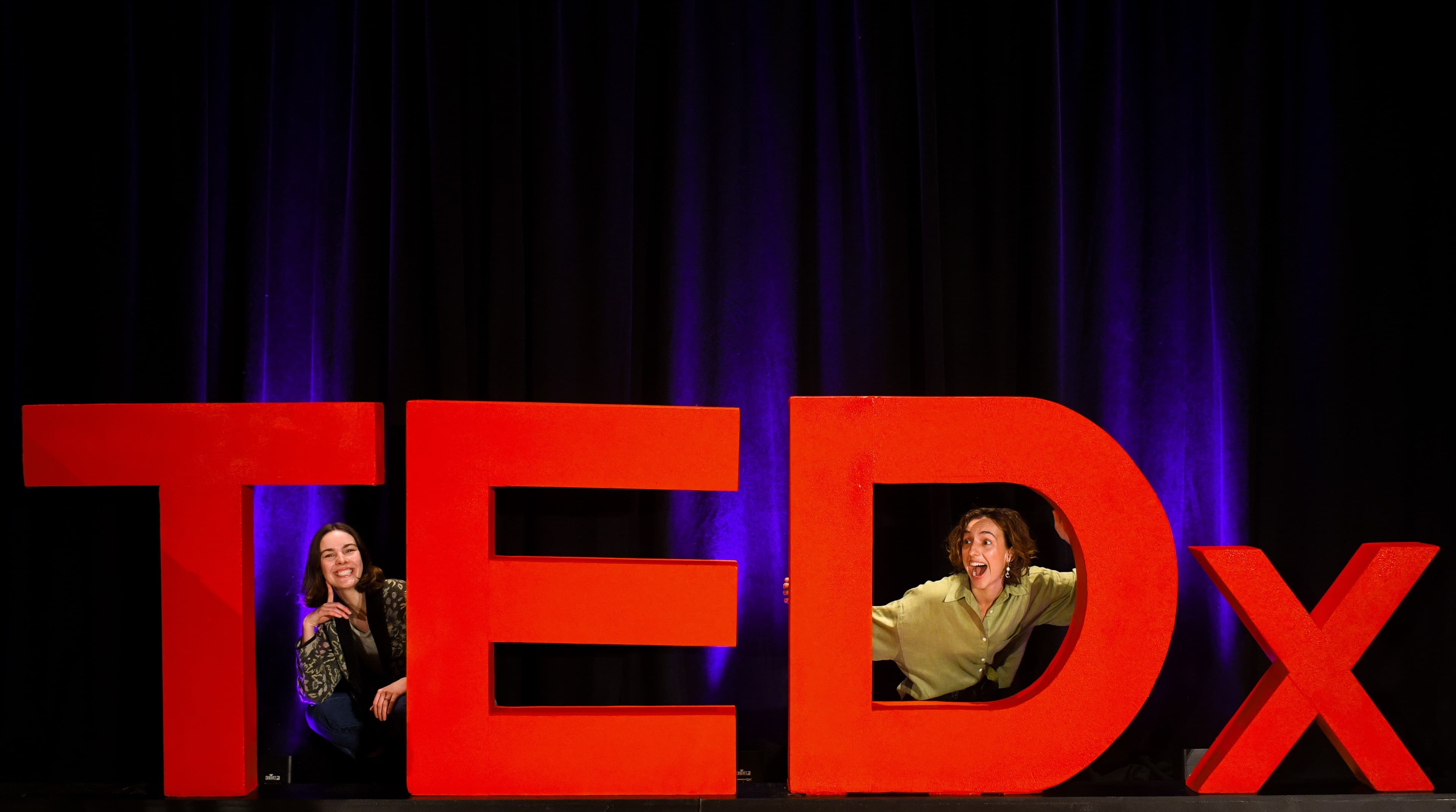 Jillian and Masha posing with TEDx letters